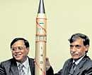 Chief military scientist V K Saraswat, left, and Programme Director AGNI missile Avinash Chander pose with a model of the Agni missile in New Delhi on Wednesday. AP