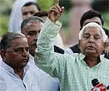 Samajwadi Party leader Mulayam Singh Yadav, left, looks on as Rashtriya Janata Dal party president Lalu Prasad Yadav talks to the media against the Women's Reservation Bill, outside the Indian Parliament in New Delhi on Tuesday. AP