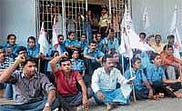 DYFI members staging a protest outside District Wenlock hospital in Mangalore on Sunday. DH Photo