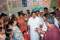 Zilla Panchayat President Kemparaj inspecting Vijayanagar Anganwadi centre on Thursday to check for substandard food supplied to Anganwadi. DH Photo