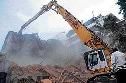 BMRCL workers demolishing the Plaza theatre complex on M G Road. DH Photo