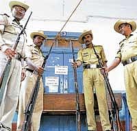 Policemen guarding the strong room where the electronic voting machines have been lodged at RV College in Bangalore on Monday. DH Photo