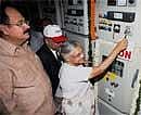 Delhi Chief Minister Sheila Dikshit dedicates a 66/11kv Grid for Commonwealth Games as Delhi Finance Minister A K Walia looks on, in New Delhi on Saturday. PTI