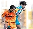 Chandnis Javed OK (left) and Golden Threads Ajith Fermin vie for possession in a I-League Second Division match in Bangalore on Saturday. DH Photo