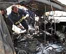 Rescue teams and security forces inspect the scene of a massive explosion near the Iranian embassy in central Baghdad on April 4, 2010. AFP