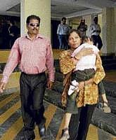 Placido Carvalho, left, leaves with his wife and child from the Goa State Childrens Court in Panaji on Monday. Carvalho, is facing charges of culpable homicide, sexual assault and destroying evidence in the 2008 death of British teenager Scarlett Keeling. AP