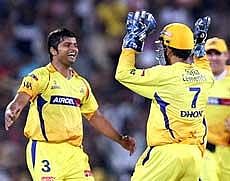 Chennai Super Kings Suresh Raina (left) and M S Dhoni celebrate the fall of Mumbai Indians Ambati Rayudu. PTI