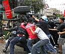 Anti-government demonstrators try to remove an abandoned Thai Army vehicle on Sunday morning. AP