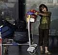 A child passenger waits after flights were canceled following volcanic eruption in Iceland at the Chhatrapati Shivaji International Airport in Mumbai, India