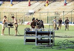Workers removing chairs, banners, hoardings and equipment from Chinnaswamy stadium following the shifting of IPL T20 matches to Mumbai on Monday. DH photo