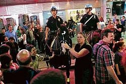 Pedestrians surround two mounted police officers in Times Square, New York City, on Monday. AFP