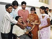 Jubilant: PUC students T R Manjunath (Science 578), K S Suprith (Commerce 581), A L Parashuram (Commerce 587), L Archana (Commerce 587), K S Sanjana (Commerce 581) and K J Sunjana (sitting on a wheel chair) celebrating their success in Bangalore on Friday. DH Photot