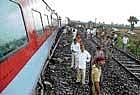 Policemen inspect the derailed New Delhi-Dibrugarh Rajdhani Express near Naugachia railway station in Bihars Bhagalpur district on Tuesday. PTI