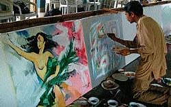 Artists painting on the canvas to protest against MSEZ at Sandesha in Mangalore on Saturday.