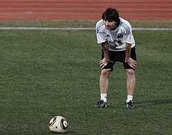 Argentina's Lionel Messi looks up behind the ball during a practice of his soccer team in Pretoria, South Africa. Argentina will play Germany in the quarterfinals of the World Cup on July 3. AP