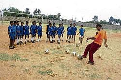 Here we go: Young footballers being trained by trainer Naseer. DH Photo