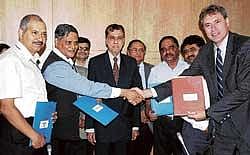 New vistas: Sector Coordinator Infrastructure and Lead Transport Specialist, World Bank, India, Den Eijbergen (right) and Joint Secretary , Anup K Pujari greet each other during signing of an MoU on Rural Water Supply and Sanitation Project in Karnataka in Bangalore on Saturday. Chief Secretary, SV Ranganath, Principal Secretary, RDPR, P Ravikumar and others are seen. DH Photo