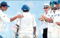 Honouring a warrior: Indian players and umpire Daryl Harper welcoming Muttiah Muralitharan, playing his last Test, to the crease at Galle on Tuesday. AP