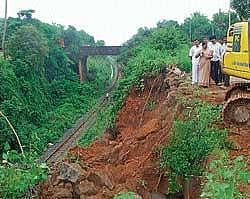 The spot being cleared off where hillock developed cracks, near Konkan railway track at Kulai, on Thursday. dh photo
