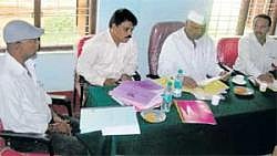 CATERING TO CATTLE: Animal Husbandry Minister Revu Naik Belamagi at a meeting to review the progress of the Department in Chikkaballapur on Friday. Deputy Director Shivaram and others are seen. DH Photo