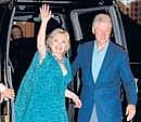 US Secretary of State Hillary Clinton waves beside her husband former president Bill Clinton as they arrive for an after-party for their daughter Chelsea in New York on Friday.