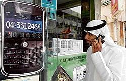 A man walks past a sign advertising the BlackBerry mobile phone at a shopping mall in Dubai as the Gulf business hub stated it will suspend key BlackBerry services from October because they are incompatible with local laws and raise security concerns. AFP