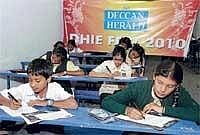 Students taking part in the DHiE short story writing competition organised by The Printers (Mysore) Private Ltd at the Army Public School on Saturday. DH Photo