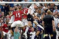 Rising High: Fulham's Brede Hangeland (centre) jumps to head a stoppage time equaliser against Manchester United during their English Premier League clash on Sunday. AP