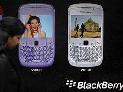 A woman walks past a Blackberry advertisement billboard in Mumbai. Reuters File Photo