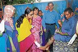 Care: Doctors inspecting a patient at the District Rehabilitation Centre in Mysore on Monday. A free medical camp was held at the centre. DH Photo
