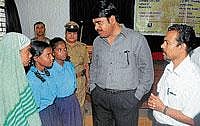 whats your story?: DCP Basavaraj Malagathi interacting with girls at a programme in Mysore on Thursday. Secretary, PLF, Babu Raj  looks on.  dh photo
