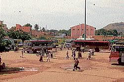 The pothole ridden private bus stand, in Chamarajnagar. Dh Photo