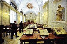 People walk past old books displayed in the reading room of the Apostolic Library of the Vatican on Monday. AFP