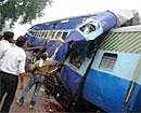Labourers weld open a mangled train compartment after a crash in Shivpuri district on Monday. AFP