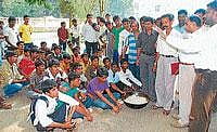 demand: The inmates of a SC/ST hostel staging a protest in front of the Deputy Commissioners office in Hassan on Tuesday, demanding basic amenities and quality food. dh photo