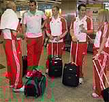 England players are seen as they check-in for their flight to attend the Commonwealth Games in New Delhi, at London's Heathrow airport, Thursday, AP