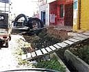 Wobbly connection: An open drainin Chintamani is causing inconvenience to the citizens. DH Photo