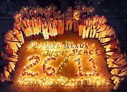 School students light candles to pay tribute to the martyrs of 26/11 Mumbai terror attacks on its 2nd anniversary in Faridabad on Thursday. PTI