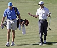 Woods, right, talking with his caddie Steve Williams as they walk the second fairway during the Pro-Am round at the Chevron World Challenge golf tournament at Sherwood Country Club in Thousand Oaks, Calif. Williams never imagined that losing his wallet could fuel so much speculation that he was on his way out as Woods' caddie. AP file photo