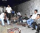 sleepless: Parents and relatives wait outside the St Francis Xavier School in Frazer Town on Friday night.  dh photo