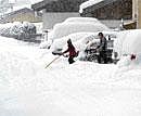 Severe winter: People clearing snow from a street in Lofer in the Austrian province of Salzburg in December 2010. (AP Photo/ Kerstin Joensson)