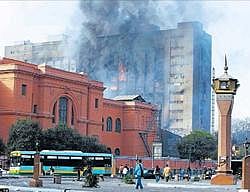 Effects of unrest: Smoke billows from the ruling National Democratic Party building behind the Egyptian Museum in Cairo. NYT