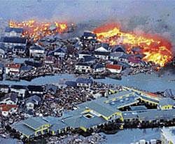 Apocalypse now: Houses are in flames while the Natori river is flooded over the surrounding area by tsunami tidal waves in Natori city, Miyagi Prefecture, northern Japan, on Friday, after strong earthquakes rocked the region. AP