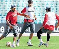 Yuvraj Singh, Munaf Patel and Mahendra Singh Dhoni play football during a practice session at the M A Chidambaram Stadium in Chennai on Saturday. DH photo/ P Samson Victor