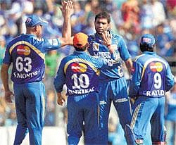 Strike force: Munaf Patel is mobbed by Andrew Symonds, Sachin Tendulkar and Ambati Rayudu after getting rid of Pune Warriors skipper Yuvraj Singh at the Wankhede stadium in Mumbai on Wednesday. PTI