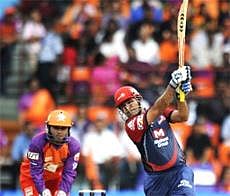 Delhi Daredevils batsman Virender Sehwag watched by Kochi Tuskers Kerala wicketkeeper Parthiv Patel plays a shot during the IPL Twenty20 match between Kochi Tuskers Kerala and Delhi Daredevils at The Jawaharlal Nehru International Stadium in Kochi on Saturday. AFP Photo