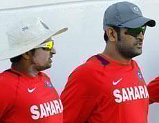 ndia's captain Mahendra Singh Dhoni, right, and Suresh Raina stretch at the beginning of a practice session in Kingston, Jamaica, Saturday . AP