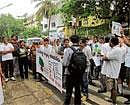 All for trees: Activists stage a protest in front of the house of C N Ashwath Narayan, MLA, Malleswaram, in Bangalore on Sunday demanding that the BBMP shelve the plan to widen the Sankey Tank Road. DH Photo