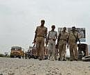 Policemen patrol on a highway during farmers protest in Greater Noida on Sunday. PTI