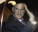 Greek Prime Minister George Papandreou waves from his car as he leaves the presidential palace after a meeting with President Karolos Papoulias and Conservative leader Antonis Samaras in Athens on Saturday. Reuters